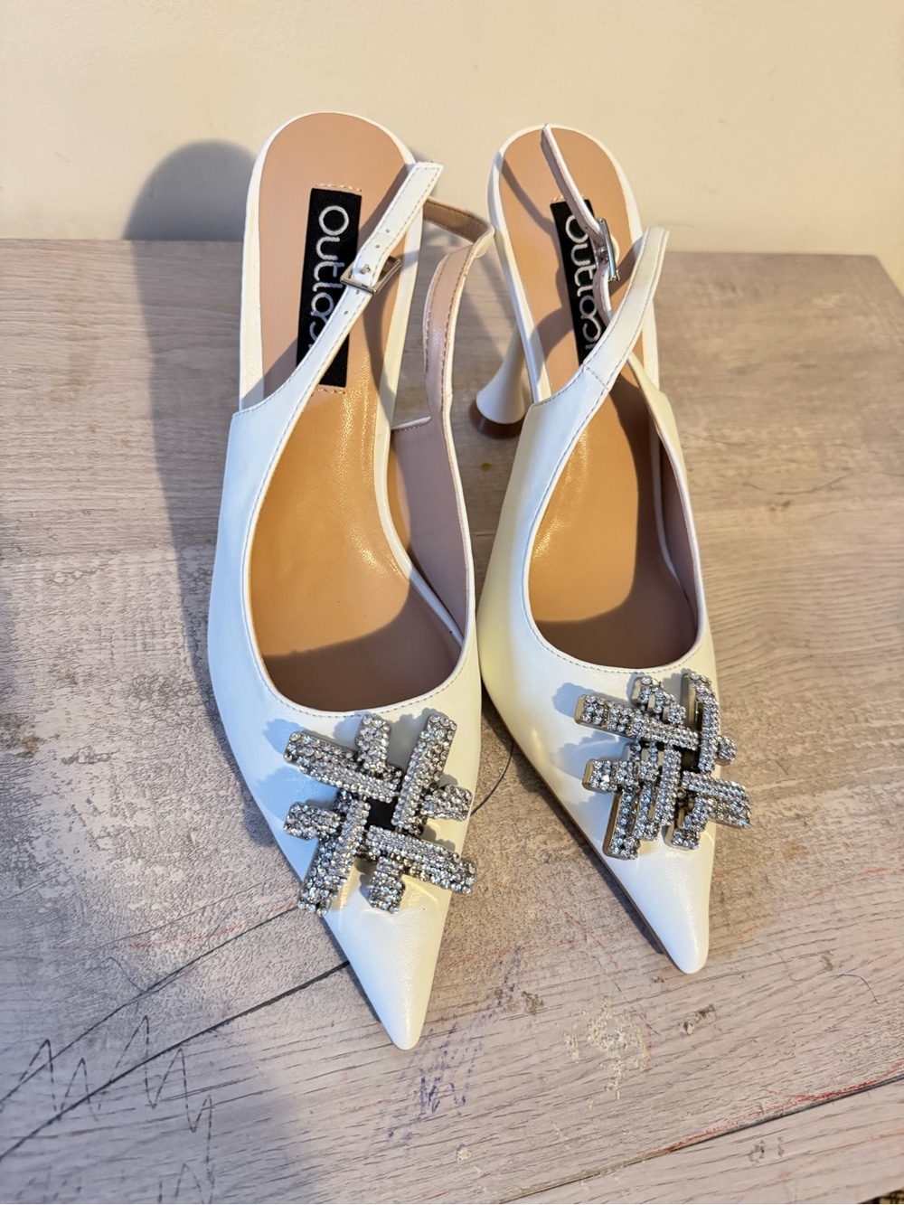 White Pointed Slingback Heels with Crystal Emblem by